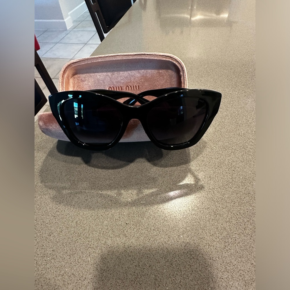Miu Miu black sunglasses.